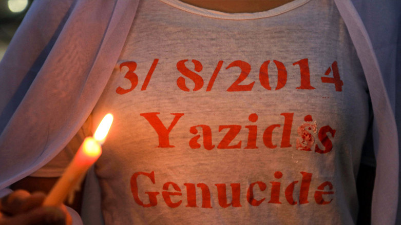 A Yezidi girl lights up a candle to commemorate the sixth anniversary of the genocide in Sharya, northern of Duhok province in the Kurdistan Region, August 3, 2020. (Photo: Safin Hamed/AFP)